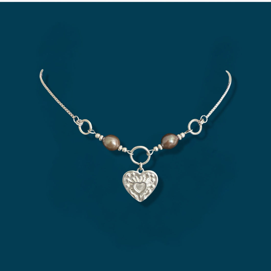 Brown Pearl with Hands Holding a Heart Pendant